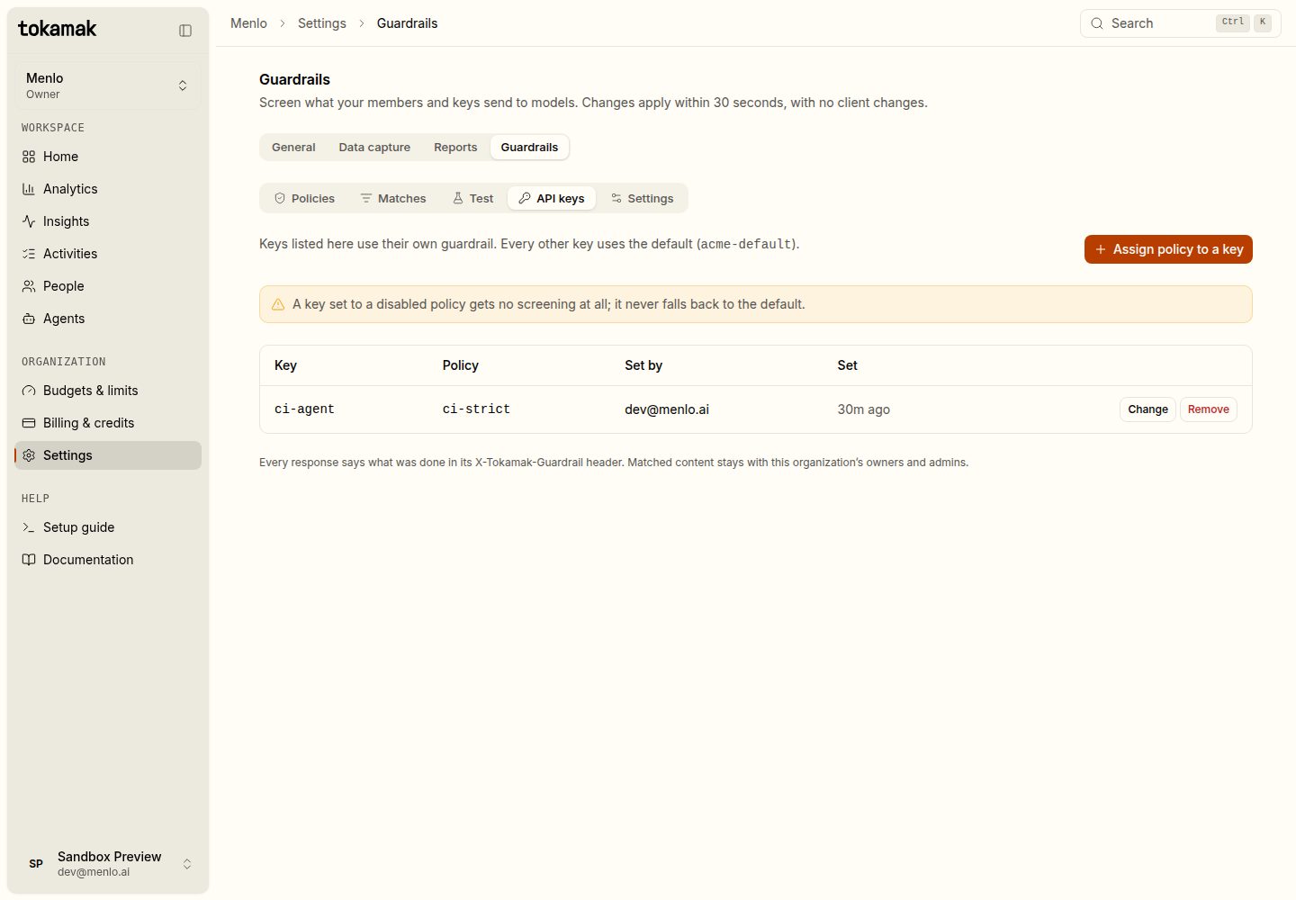 The API keys tab: the ci-agent key uses the ci-strict policy; every other key uses acme-default